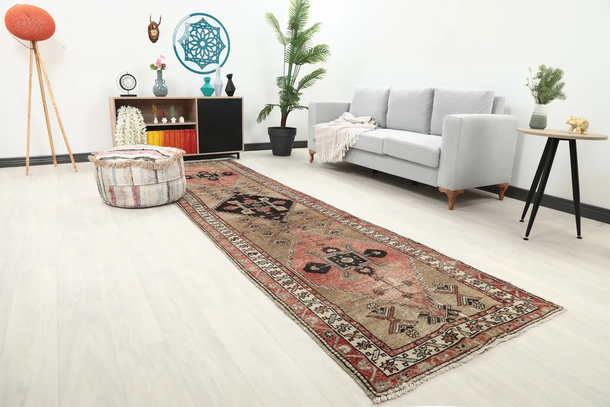 Long view of the Anatolian runner rug in a room setting, highlighting its placement along a wall.