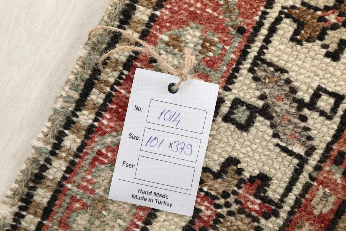Tag showing the rug's dimensions and origin, placed on the woven back of the rug.