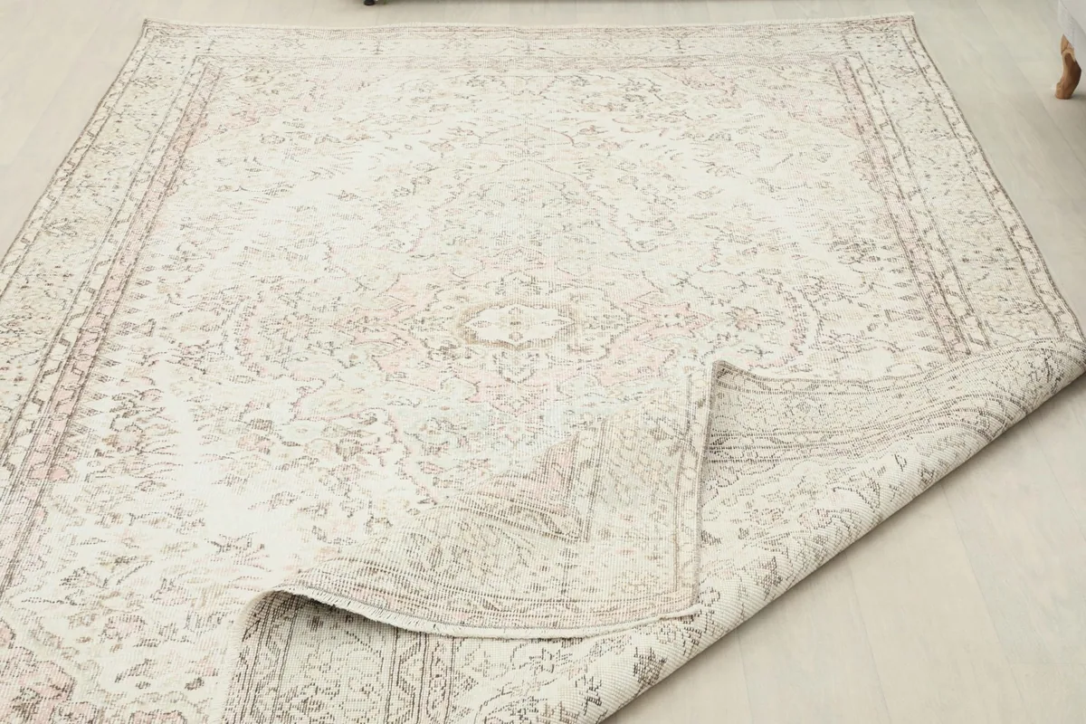 Rug partially folded to show its flexibility and the reverse side.
