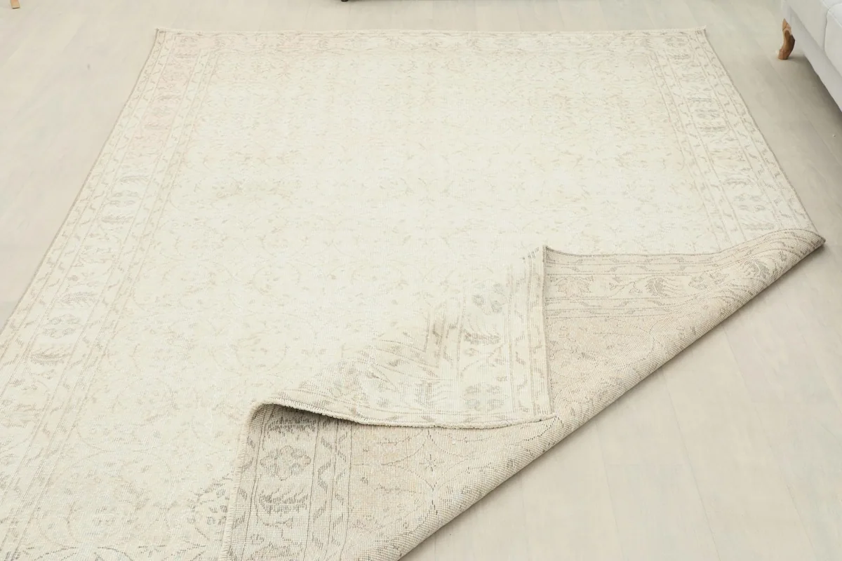 Partial view of the rug's back, revealing the hand-knotted construction and foundation