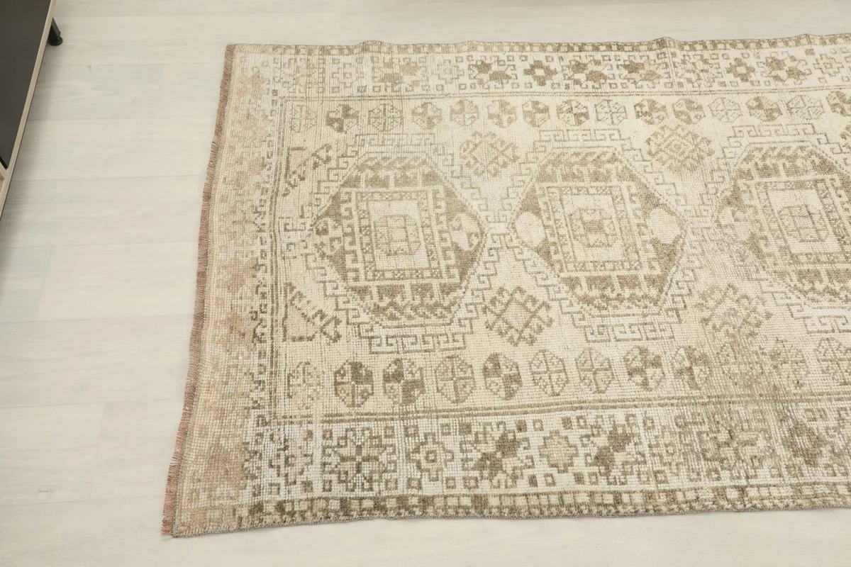 Close-up of the rug's border and central design, revealing the hand-knotted texture