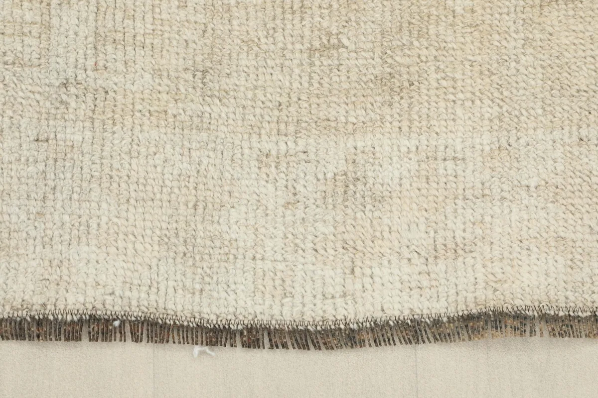 View of the rug's cotton foundation and the back of the hand-knotted construction