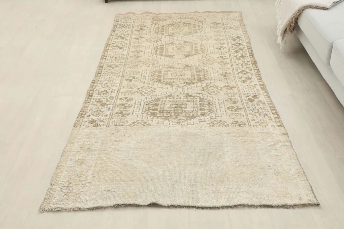 Overhead shot of the full rug in a room setting, emphasizing its elongated shape and design