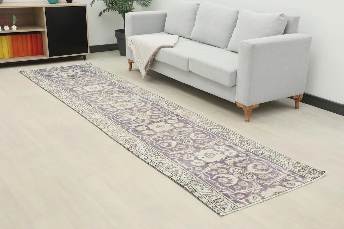 Runner rug extending from a sofa towards the foreground, highlighting its scale in a living space