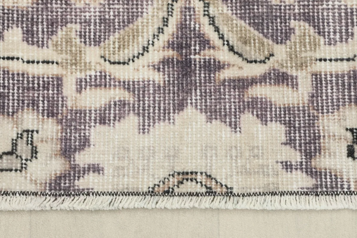 Detail of the short, natural cotton fringe at one end of the hand-knotted runner rug