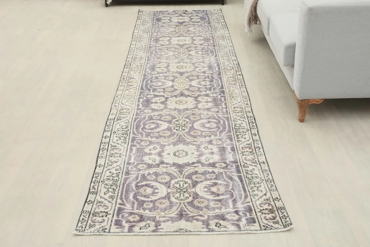 Full overhead view of the runner rug in a room setting, showing its long, narrow shape