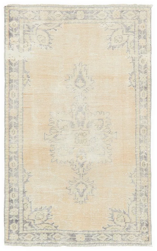 Full overhead view of the beige and gray vintage Anatolian area rug on a white background