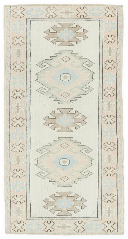 Full overhead view of the 2'9" x 5'6" ivory blue geometric Anatolian rug on a white background