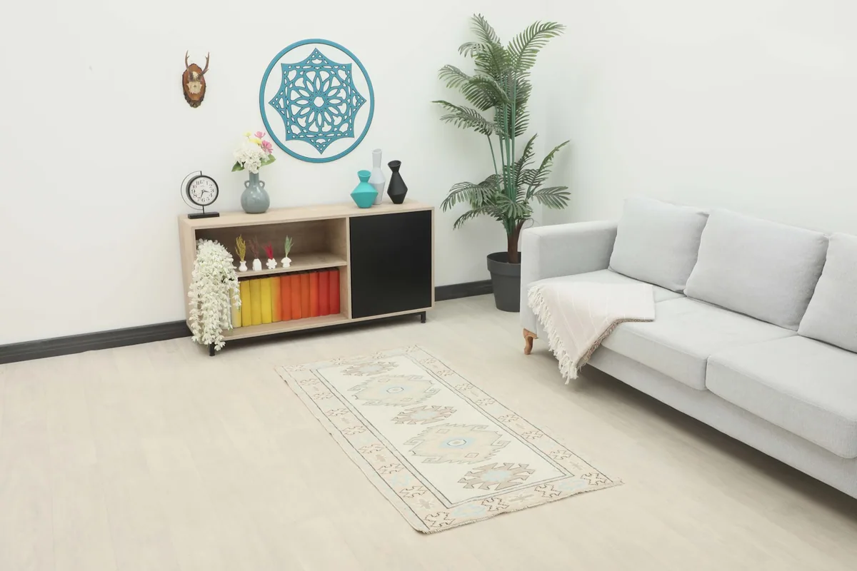 Ivory blue geometric rug displayed in a living room setting with a couch and console table