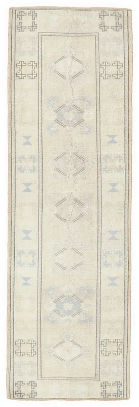 Full overhead view of the ivory and blue geometric vintage Anatolian runner rug