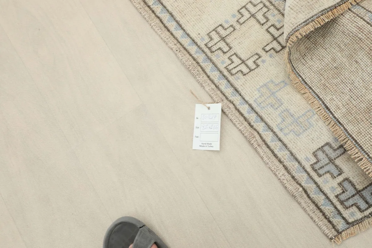 Rug tag visible on the corner of the runner, indicating its origin and material