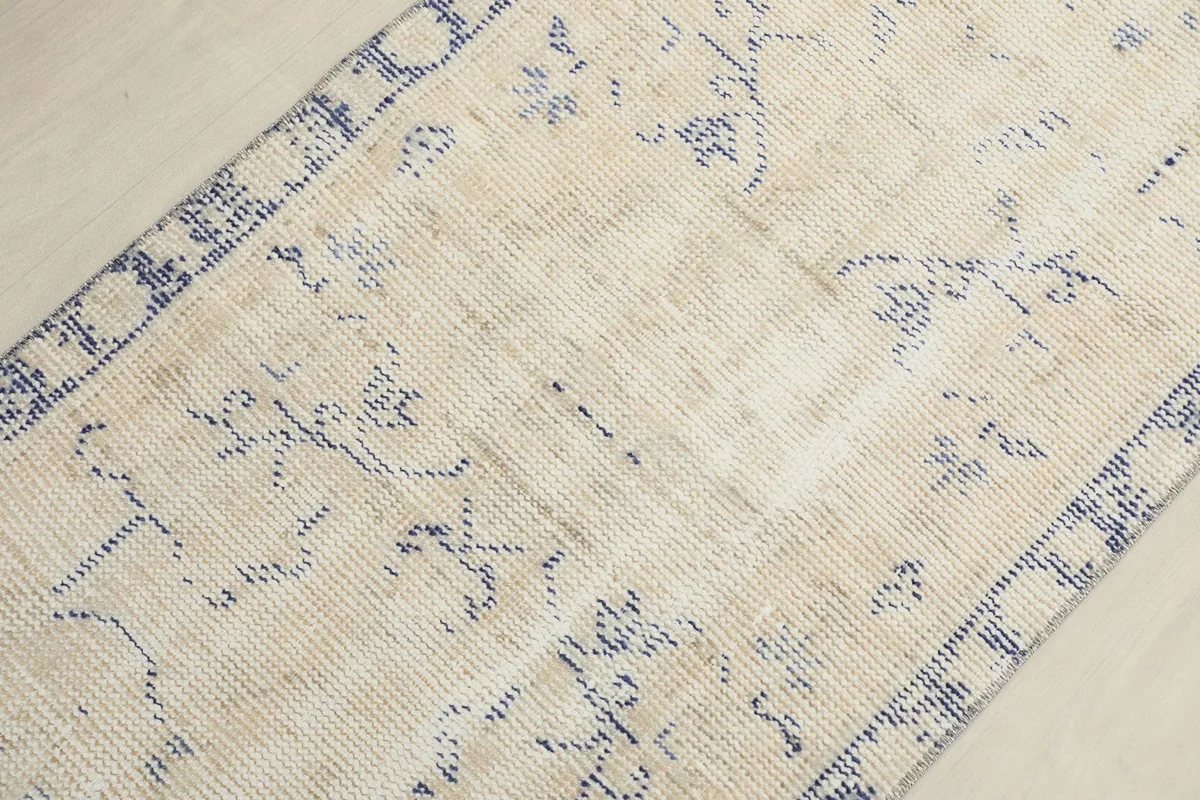 Detailed perspective of the rug's center, revealing the subtle patterns and natural wear.