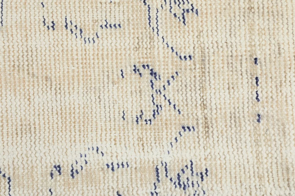 Extreme close-up of the low wool pile, showing individual knots and the distressed texture.