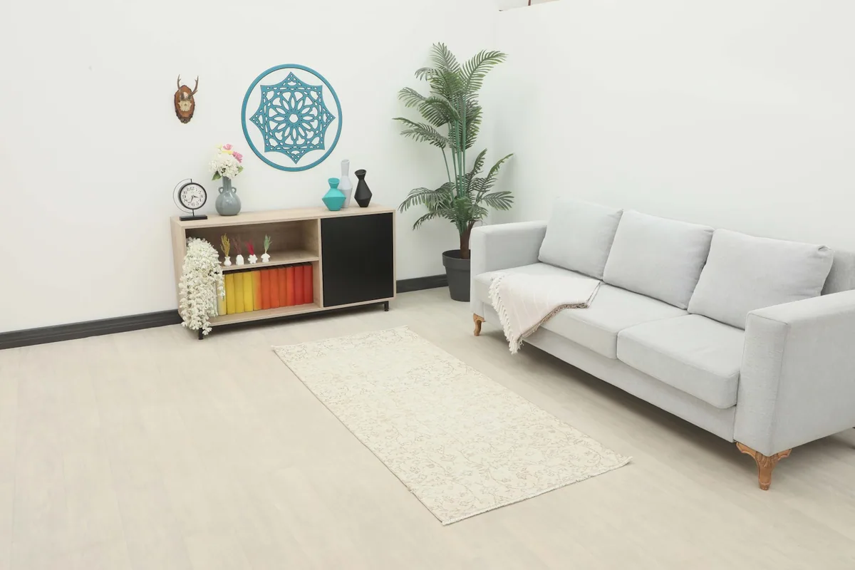 Vintage cream runner rug placed in a modern living room setting with a light gray sofa