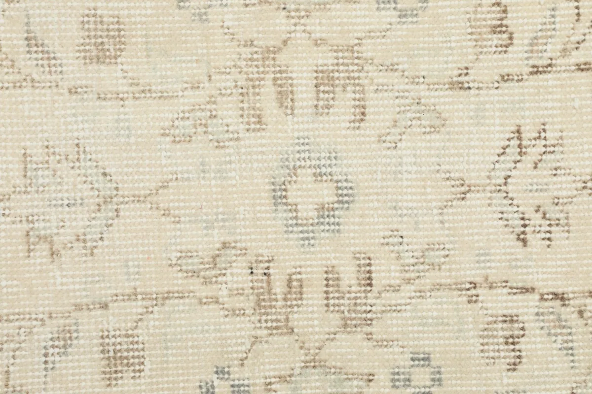 Macro shot of the hand-knotted wool pile, revealing individual knots and color variations