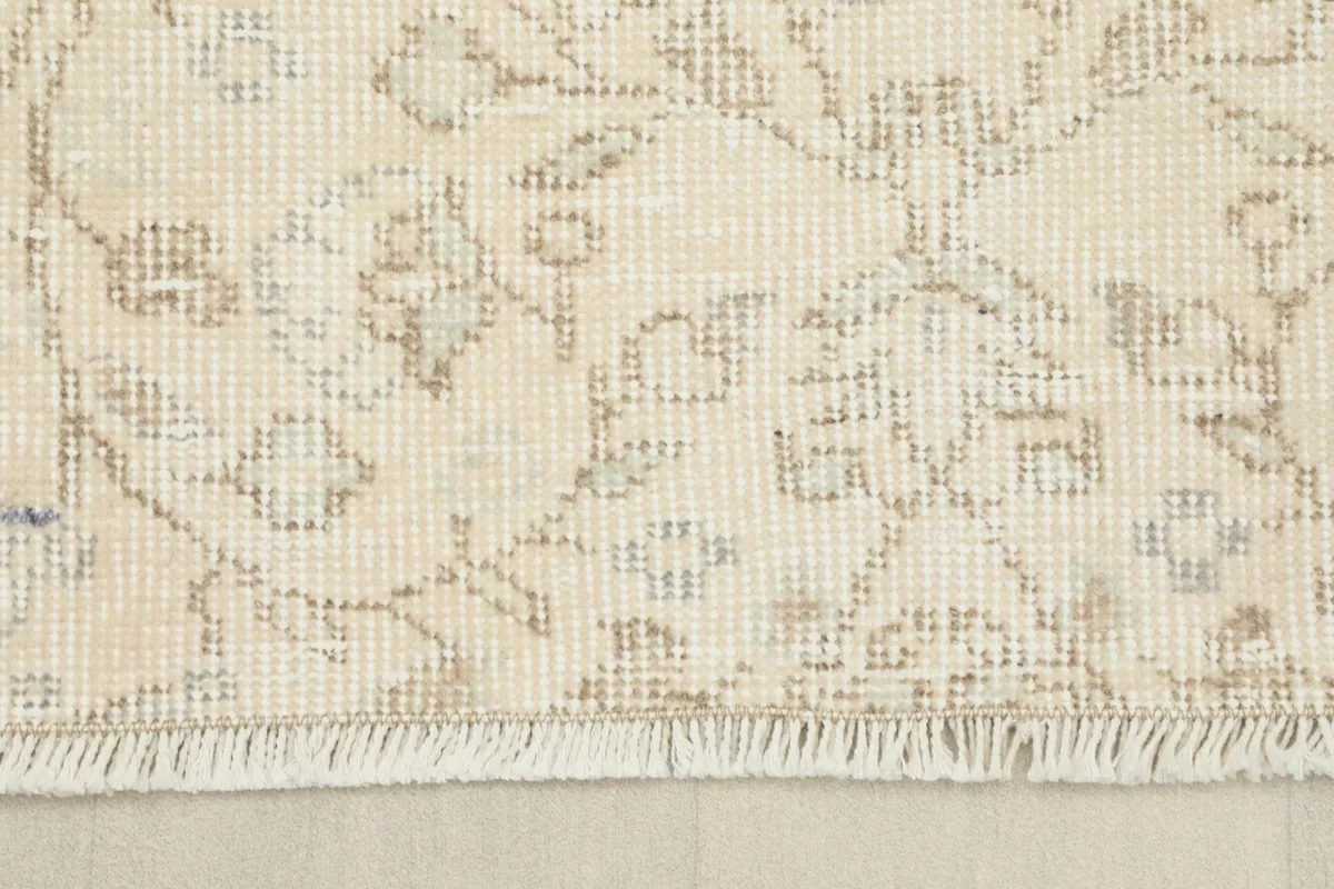 View of the short, natural fringe and the detailed floral pattern near the edge