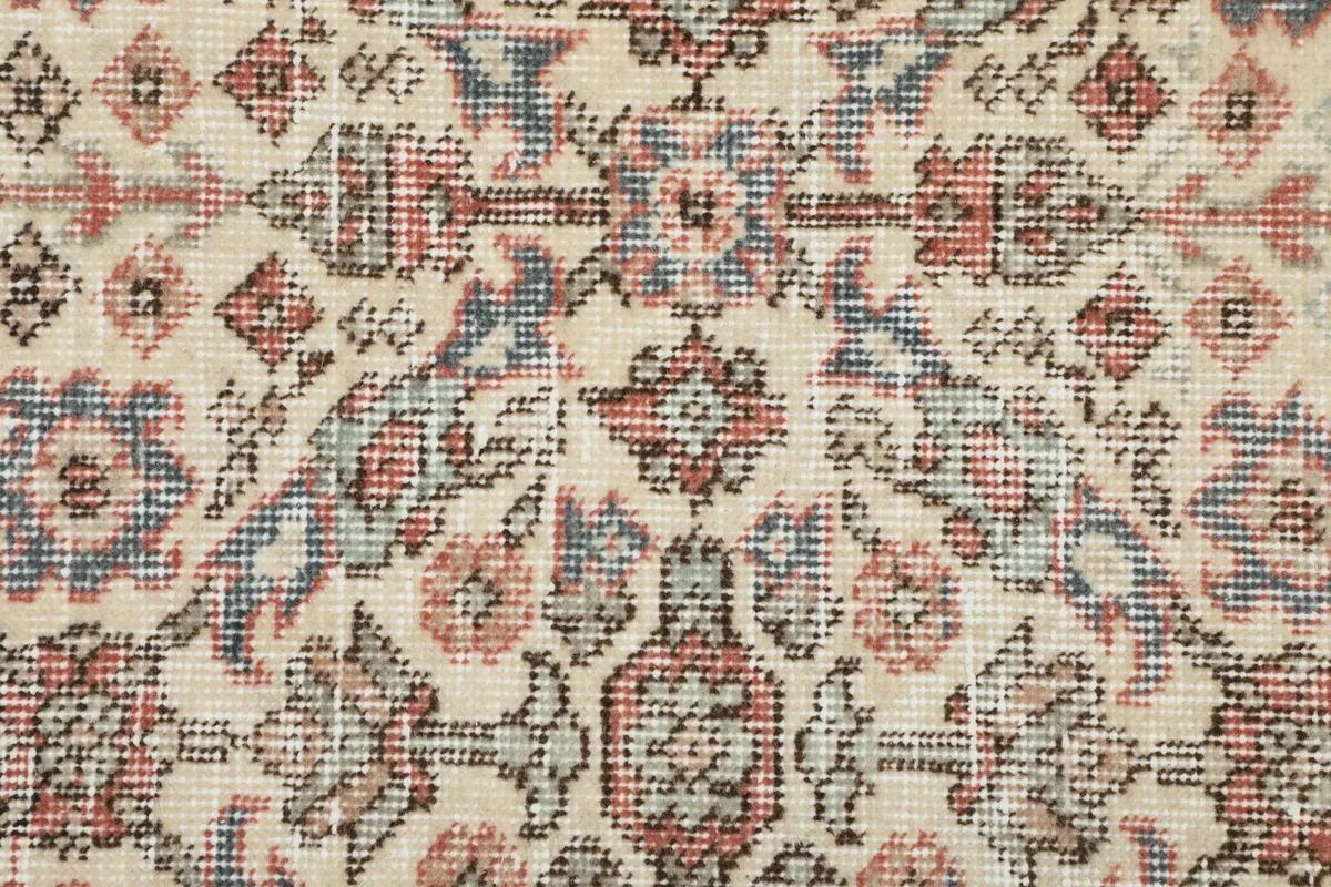 Detailed close-up of the rug's surface, revealing the hand-knotted texture and color variations in the wool pile