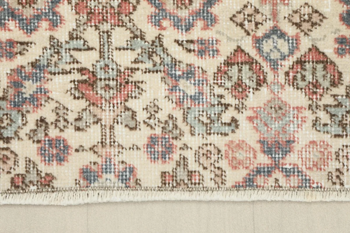 Close-up of one end of the runner, showing the short, natural cotton fringe and edge finish