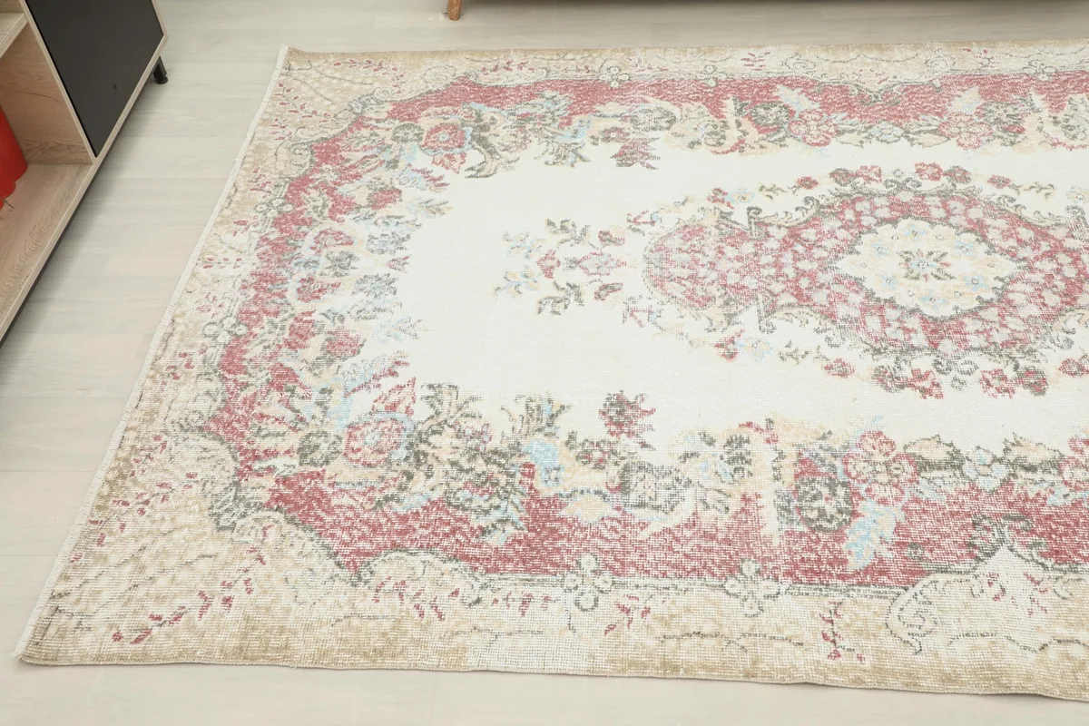 Another angled view of the rug's border and field, showing the intricate floral details.