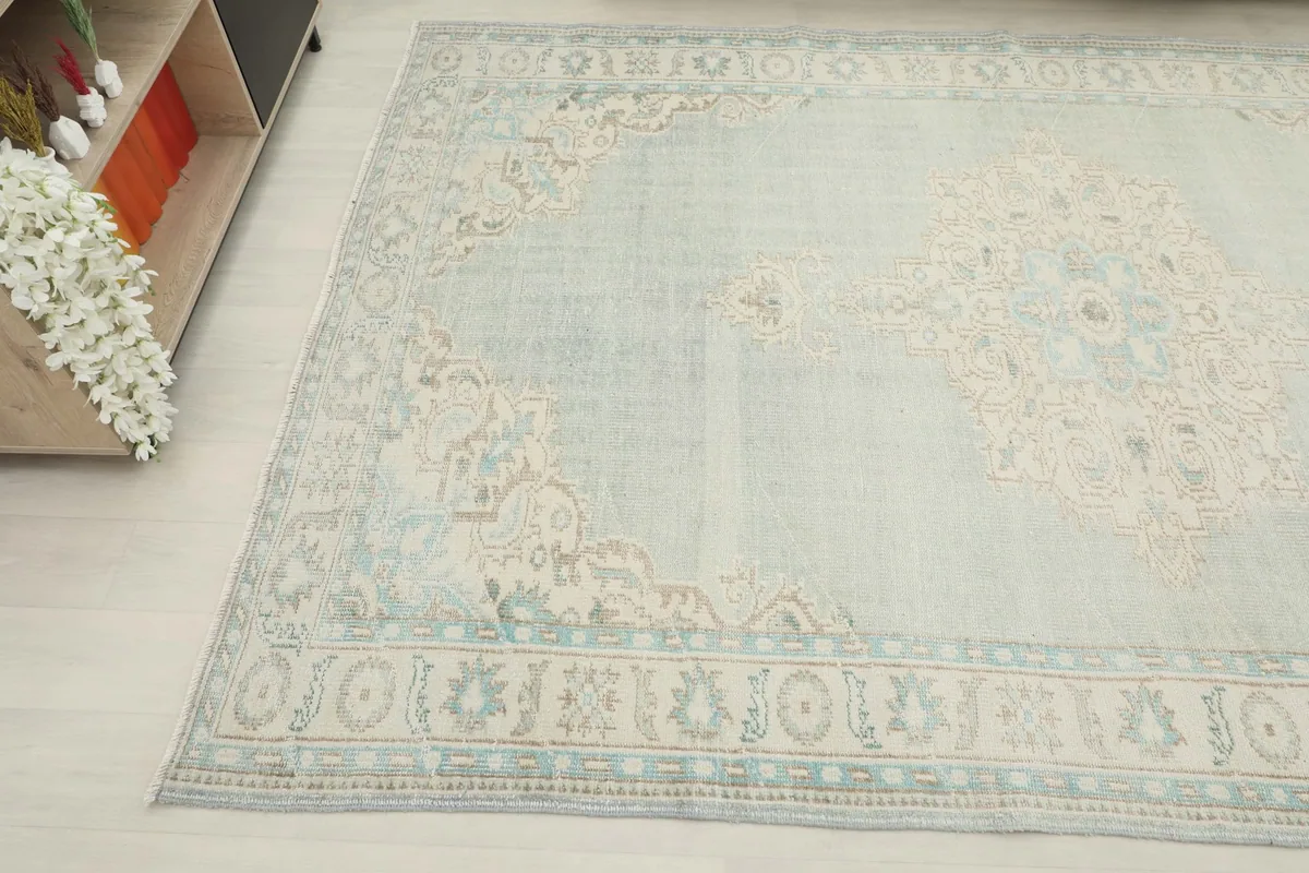 Another angled view of the rug, capturing the subtle color variations and vintage patina