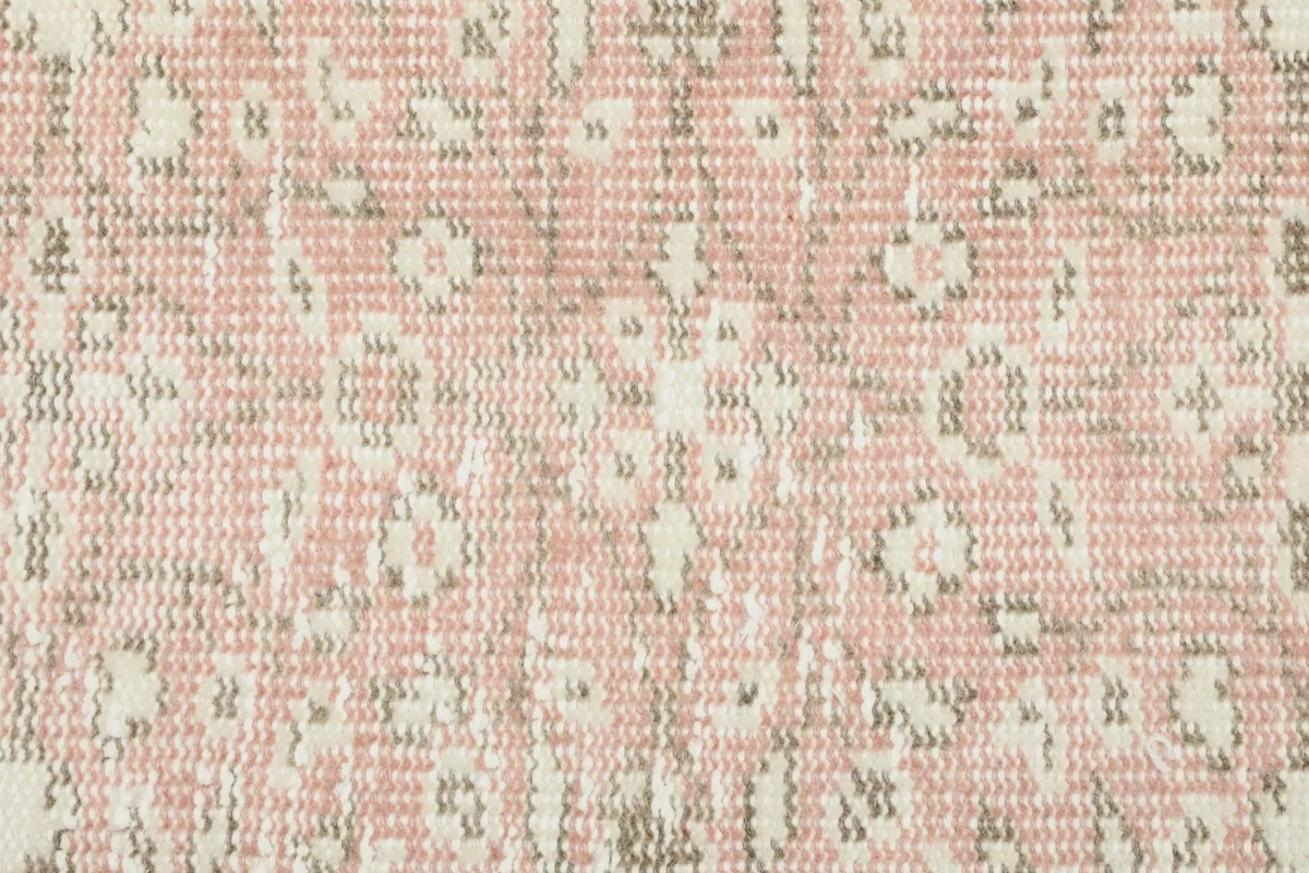 Extreme close-up of the low wool pile, showing the hand-knotted texture and color variations
