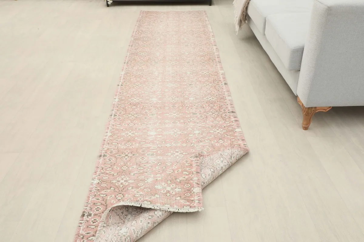 Runner rug partially folded to show its flexibility and the consistent pattern