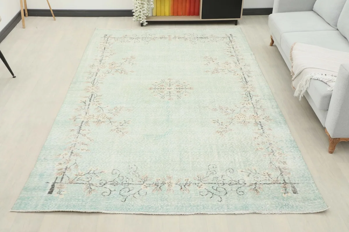 Full room view of the 6'5" x 10'5" vintage blue floral rug, anchoring the living space.