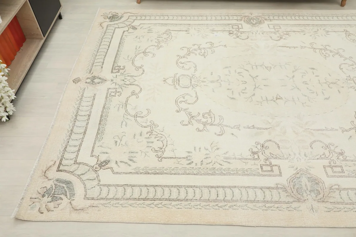 Side angle view of the rug, showing the faded patterns and natural patina