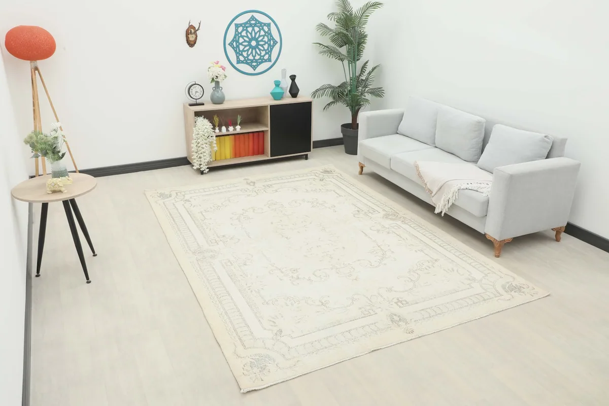 Vintage Anatolian ivory and gray rug displayed in a bright living room setting