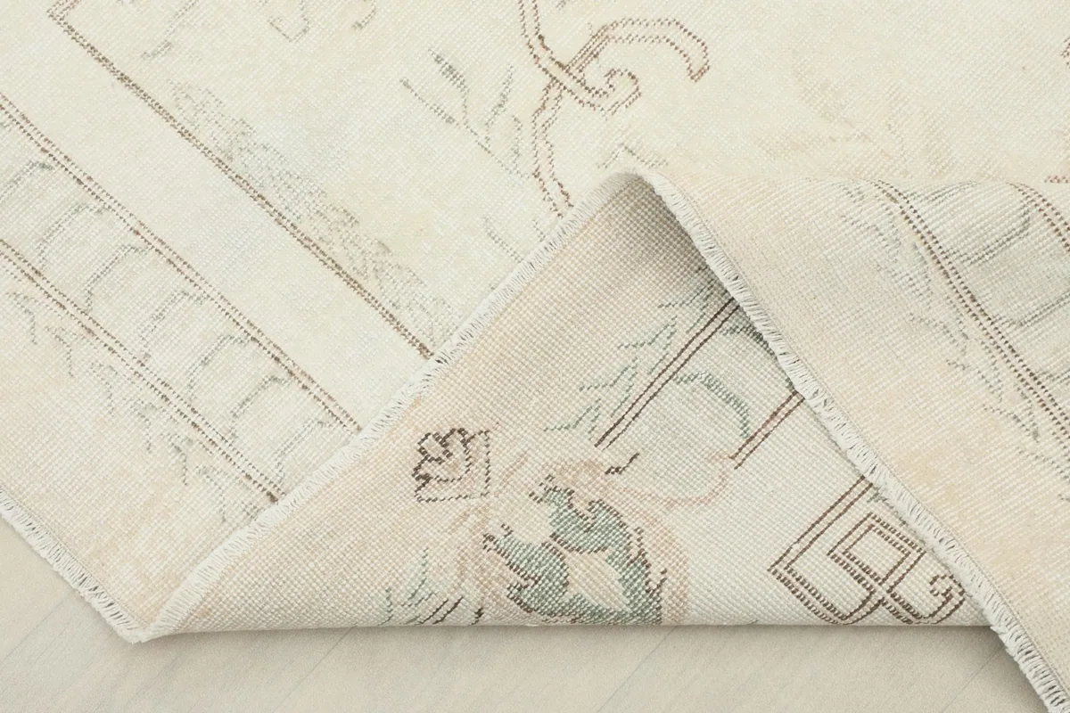 View of the rug's underside, showing the cotton foundation and hand-knotted construction