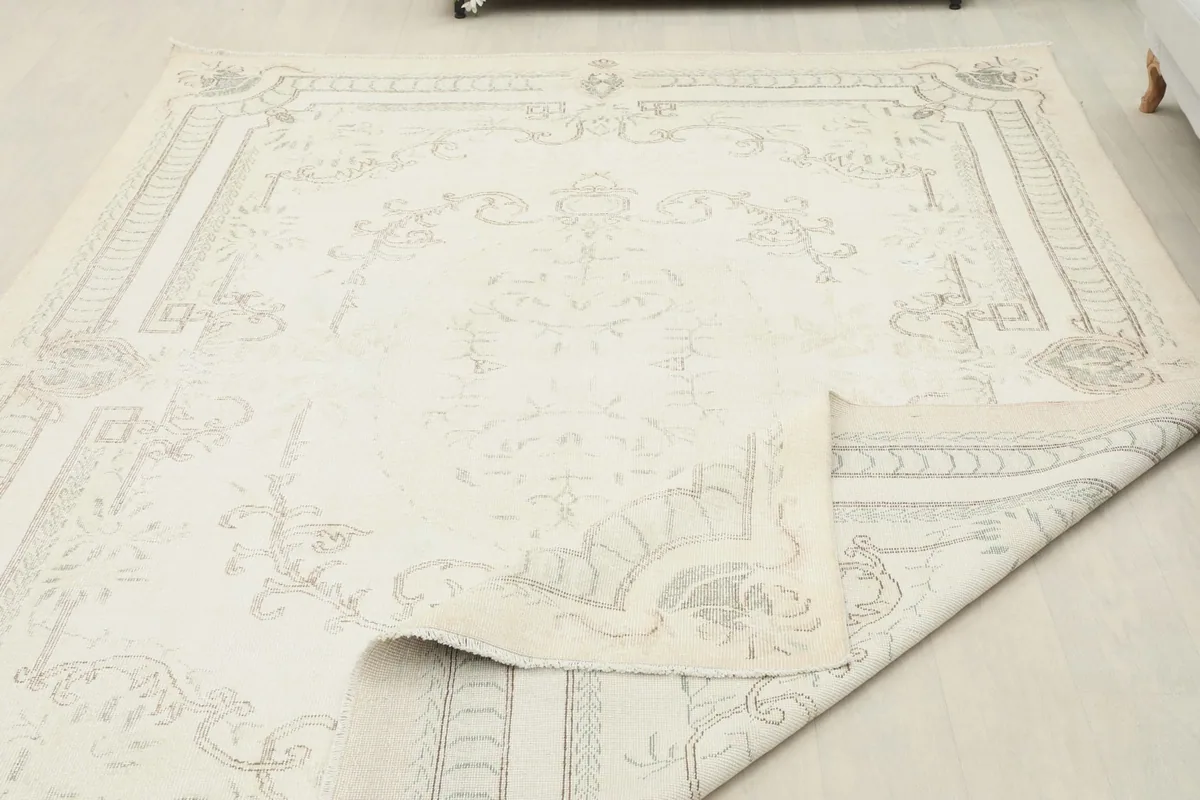 Rug folded back to reveal the back and the density of the hand-knotted wool pile