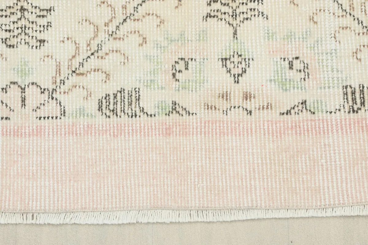 Close-up of the rose border and fringe, showing the texture and gentle color fading