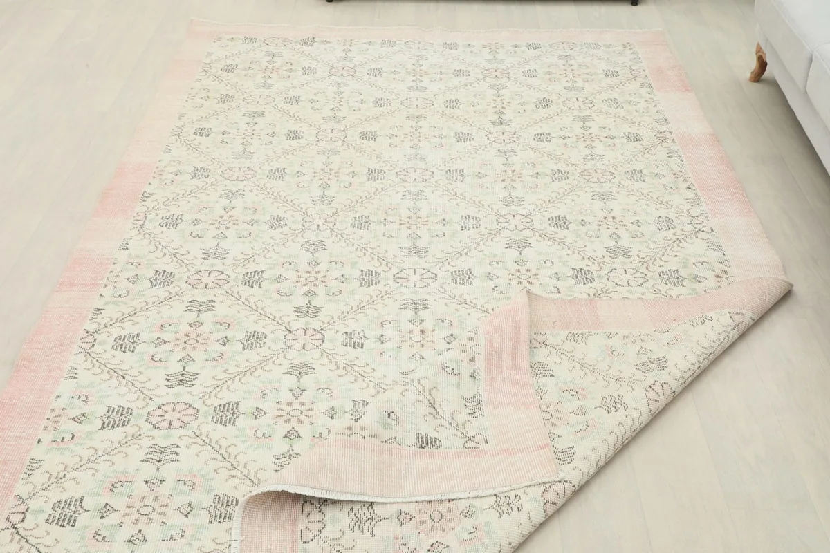 Rug with a partially folded corner, displaying the full design and construction