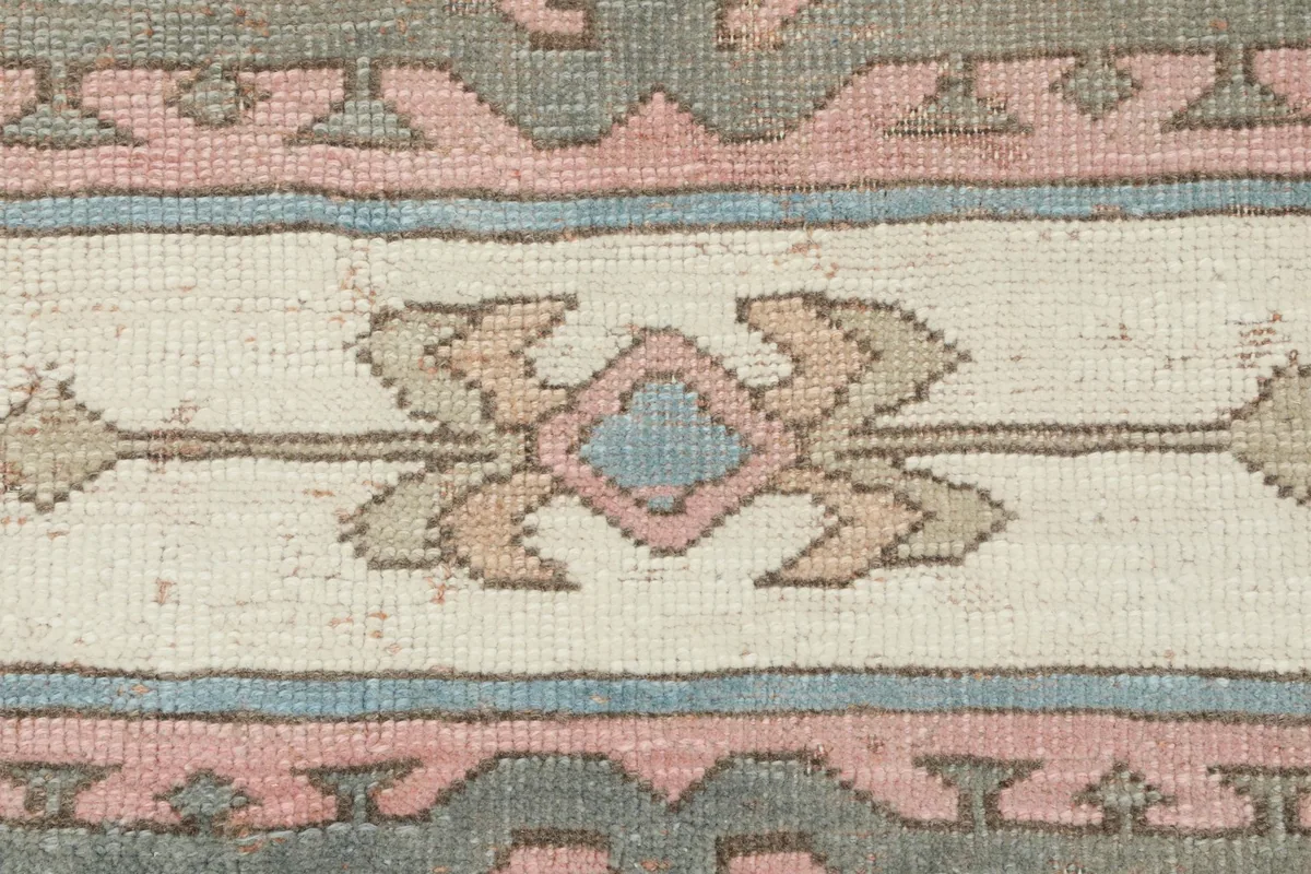 Close-up of a single tribal motif within the central column, showing intricate knotting.