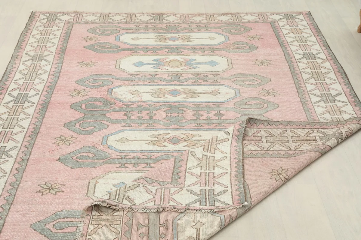Rug partially folded, illustrating its flexibility and showing the overall design.