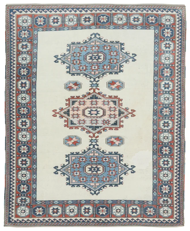 Full overhead view of the vintage Anatolian rug with ivory field and blue, navy, rust geometric patterns