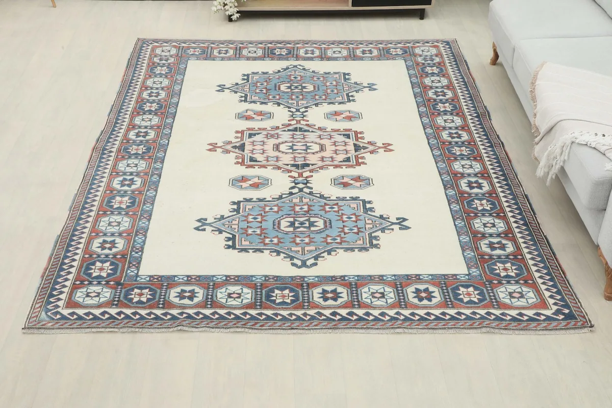 Full overhead view of the rug in a room setting, positioned in front of a light gray sofa