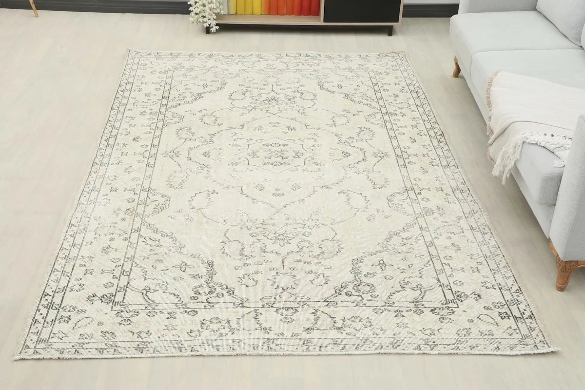 Full room view of the ivory and gray vintage Anatolian rug complementing a modern living space