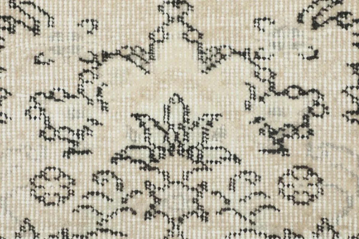 Close-up of the low wool pile, showing the hand-knotted texture and intricate gray patterns