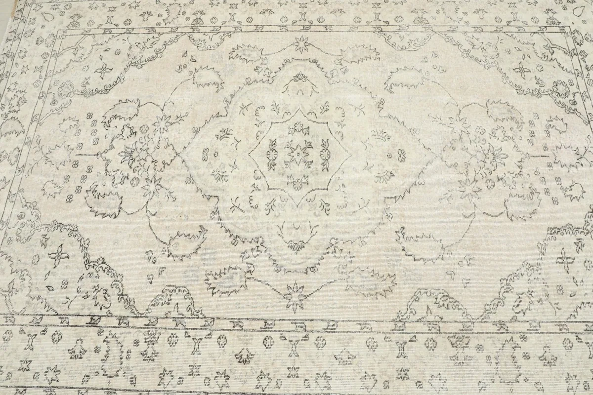 Overhead view focusing on the central medallion and surrounding field patterns of the rug