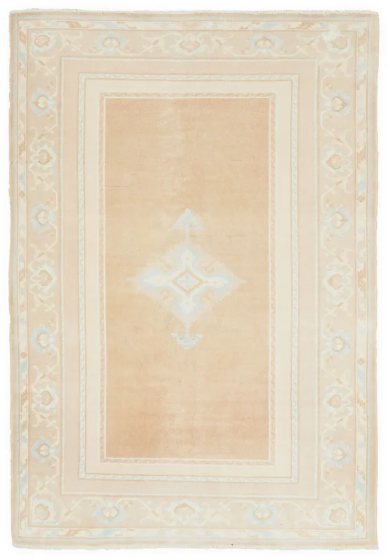 Full top view of the 5'3" x 8'3" beige vintage Anatolian rug with a central blue medallion.