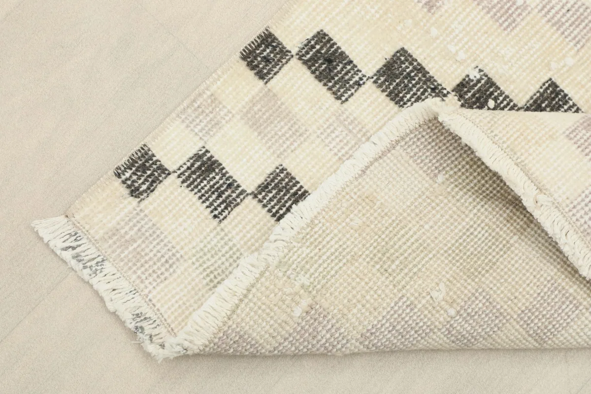 View of the back of the vintage Anatolian rug, showing the knotting structure and cotton foundation