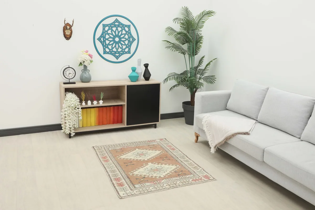Rust geometric vintage rug placed in a living room setting under a console table next to a sofa