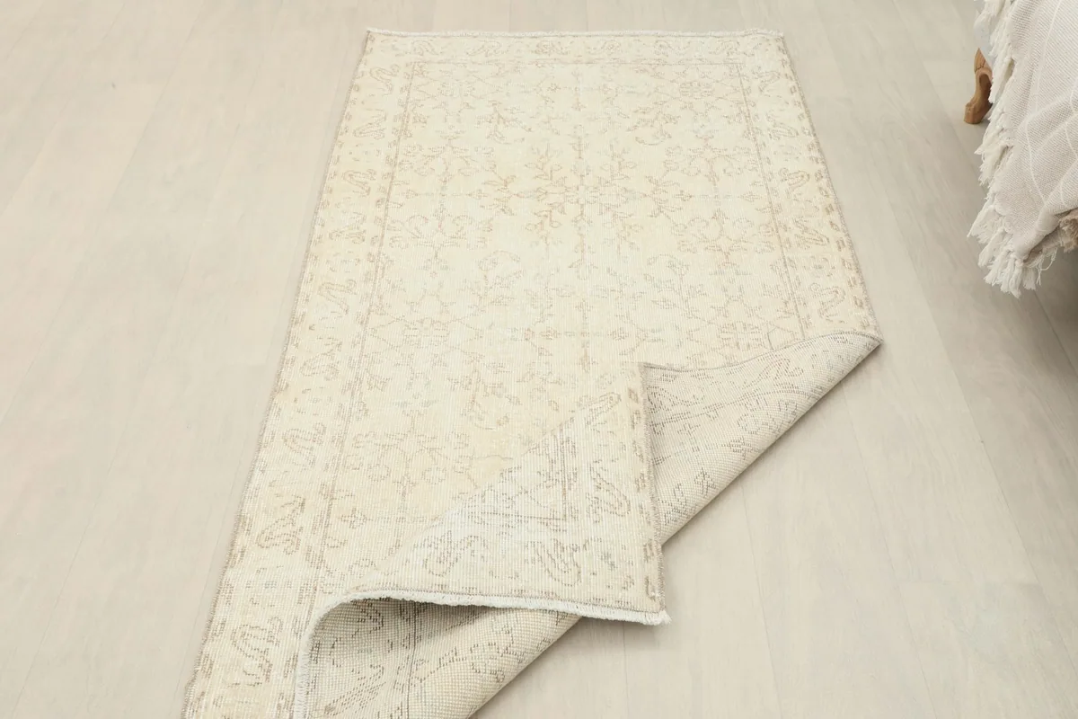 The rug partially folded, displaying both the top surface and the underside, indicating its flexibility.