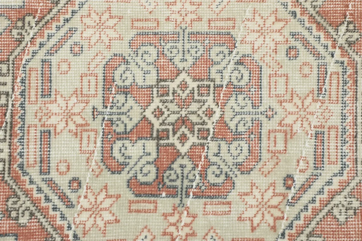 Macro shot of a central medallion, revealing the hand-knotted wool pile and subtle color variations