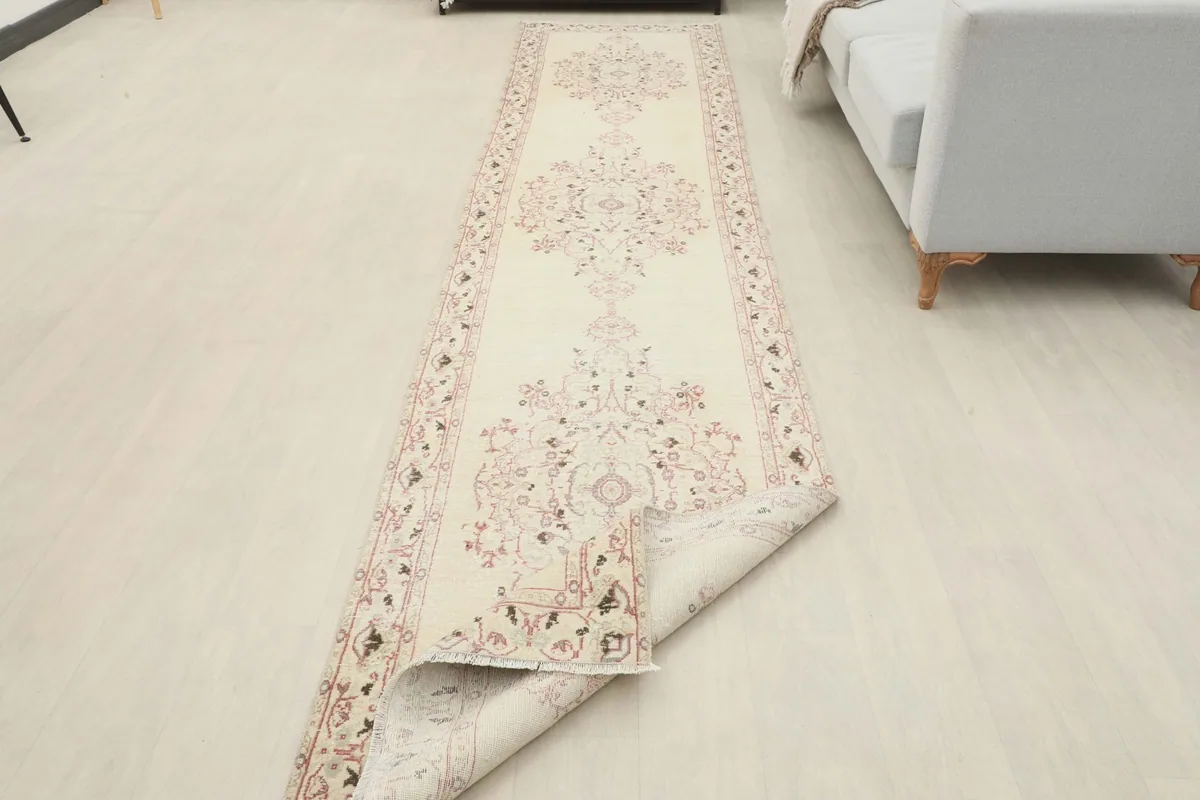 The runner rug partially folded to show its flexibility and overall length in a room