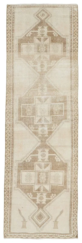 Full top view of the beige and tan geometric vintage runner rug on a white background
