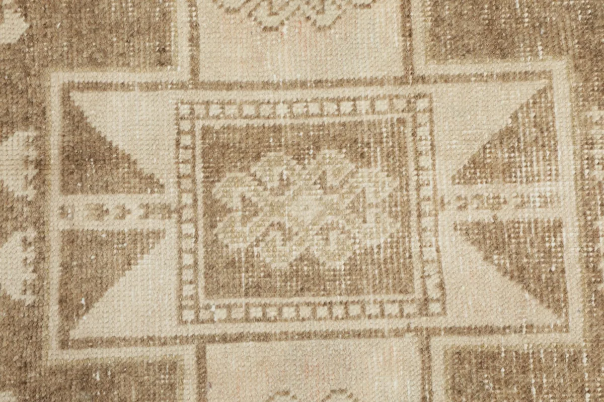 Close-up detail of the intricate weaving and colors within a central motif of the rug