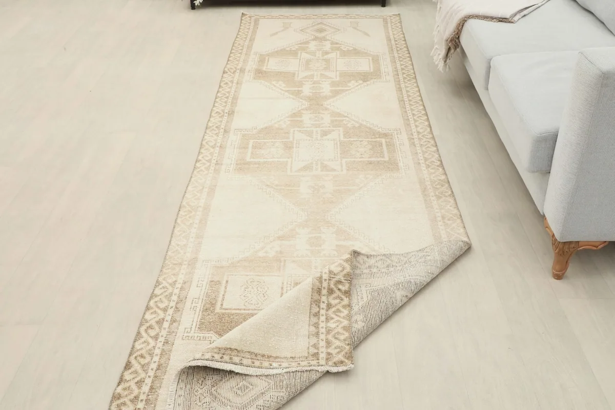 Runner rug with one corner folded back, showing the thickness and construction