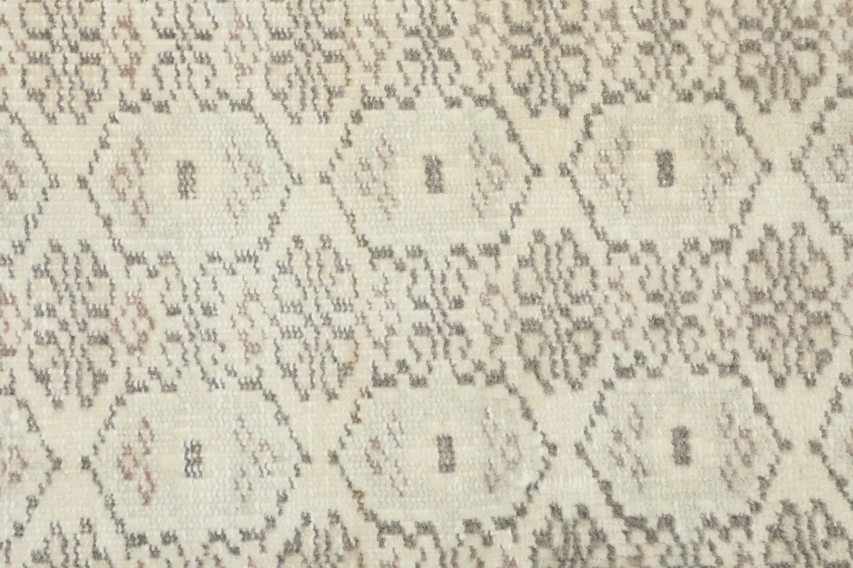 Extreme close-up of the wool pile and specific geometric elements, showing texture and color blend